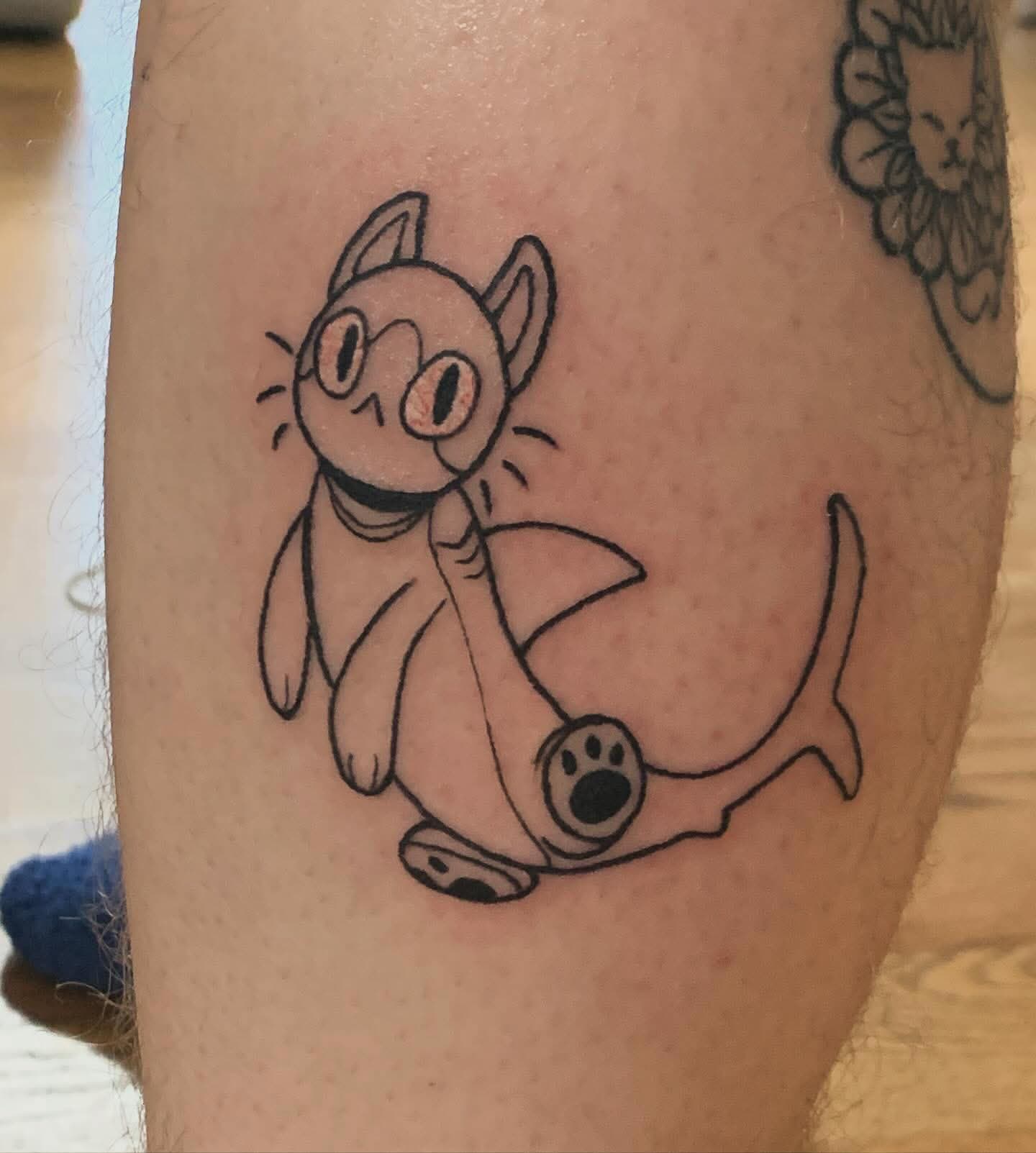 tattoo of a cat that has a shark's lower half